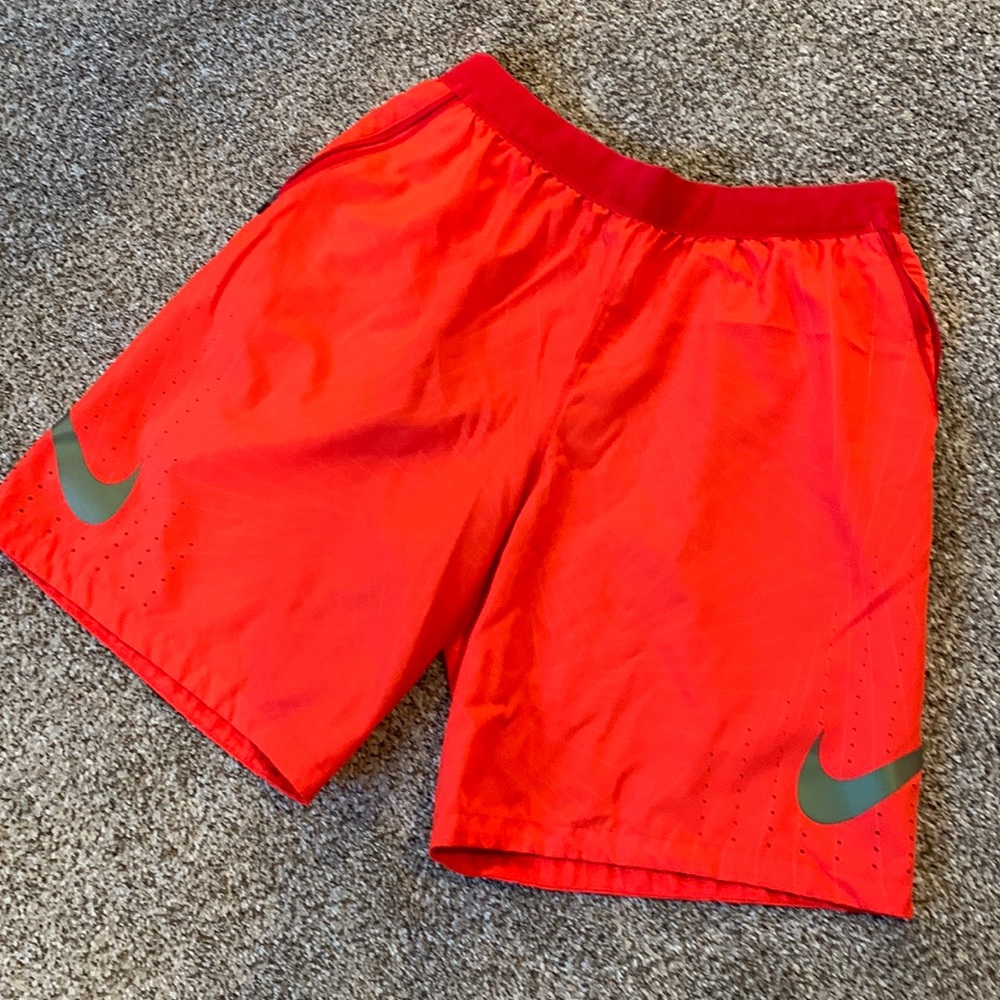 Red Nike Shorts. Used some, in good condition. Zipper pockets on both sides.